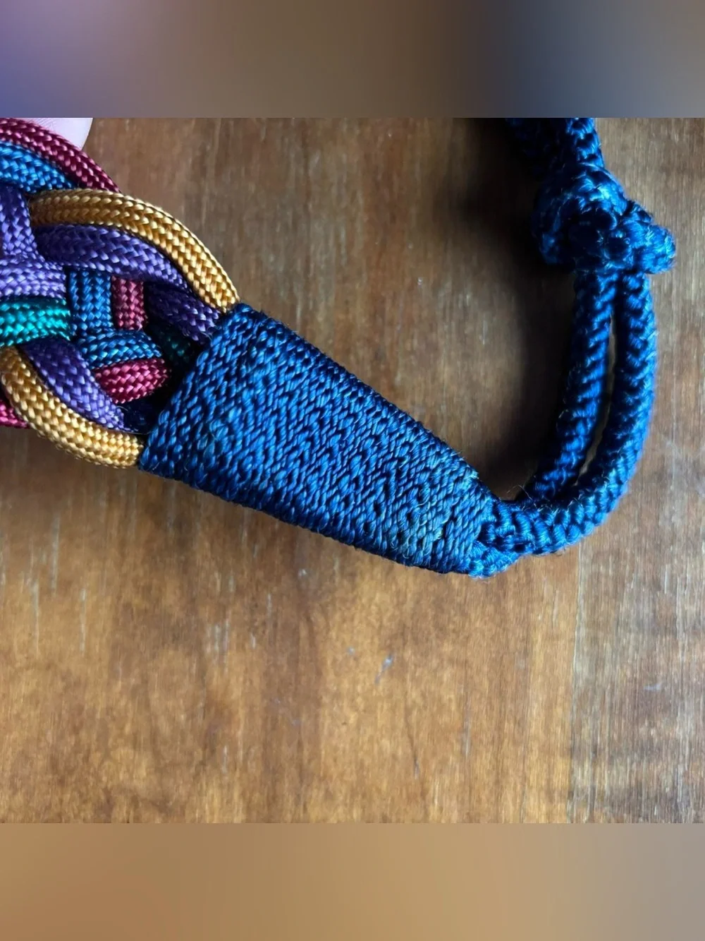 Multicoloured braided belt with decorative medallion